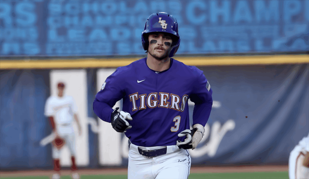 Baseball player in purple jersey running on the field