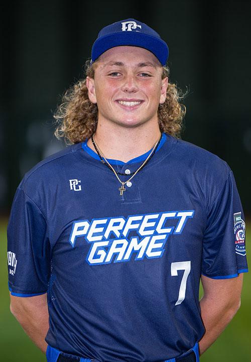 Player wearing a navy jersey with 'Perfect Game' text and number 7, smiling at the camera