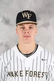 Baseball player wearing a Wake Forest uniform with a cap and a necklace