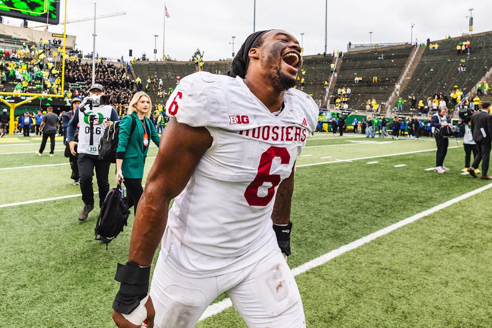 Football player in white uniform celebrating on the field