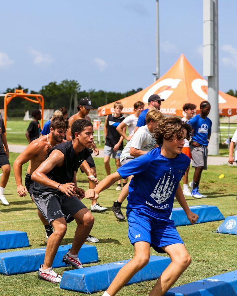 Group of young athletes performing drills on a grassy field